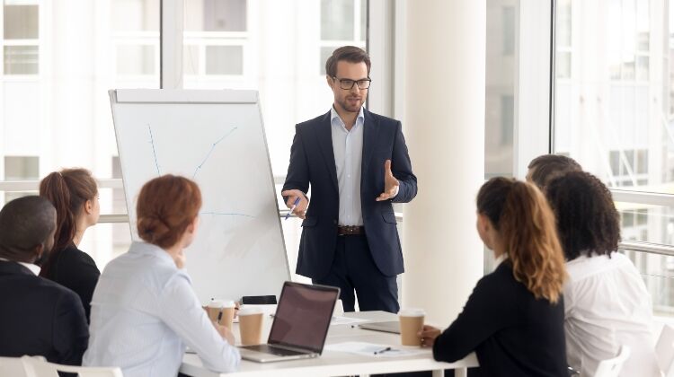 Sales Job Opportunities, Sales Recruitment. Sales Manager presenting to a team of sales professionals.